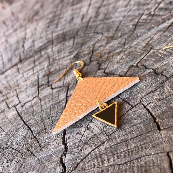 Les boucles d’oreilles avec les triangles plus grands cuivrés et mini noires avec la finition de couleur dorée