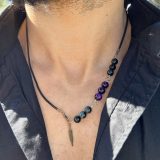 Collier Unisexe KIM Découvrez l'exclusivité du Collier Unisexe KIM - Une œuvre d'art repositionnable et ajustable pour homme et femme. Le Collier KIM se distingue par sa polyvalence exceptionnelle, conçu pour s'adapter à vos besoins et à votre style unique. Que vous préfériez un look avec un pendentif long, mi-long ou court, le Collier KIM vous offre une flexibilité totale. Sa fermeture intelligente permet de repositionner le bijou à plusieurs endroits, vous permettant ainsi de jouer avec la taille et le style, faisant de ce collier un accessoire pratique, modifiable et véritablement hors du commun. Fabriqué avec une lanière en cuir noir de haute qualité, le Collier KIM est orné d'œil de faucon et d'œil de tigre violet, des pierres semi-précieuses reconnues pour leurs propriétés bénéfiques. L'œil de faucon est réputé pour stimuler la clarté mentale, tandis que l'œil de tigre violet est associé à la protection et à l'équilibre émotionnel. La breloque de plume en bronze ajoute une touche d'élégance et de sophistication, faisant du Collier KIM bien plus qu'un simple accessoire. Collier Unisexe KIM Ce bijou unisexe KIM peut être commandé pour les deux genres, permettant un partage harmonieux. De plus, la possibilité de personnaliser les couleurs et de superposer d'autres colliers de la collection offre une infinité de combinaisons pour exprimer votre style personnel. Explorez le Collier KIM et dévoilez votre style unique, que ce soit pour une soirée chic, une journée décontractée ou un événement spécial. Avec ses pierres semi-précieuses aux vertus reconnues, ce bijou est bien plus qu'un simple accessoire de mode - c'est une déclaration de votre individualité et de votre bien-être. Commandez dès maintenant et plongez dans l'univers captivant du Collier Unisexe KIM. Exprimez-vous, soyez unique, soyez KIM !